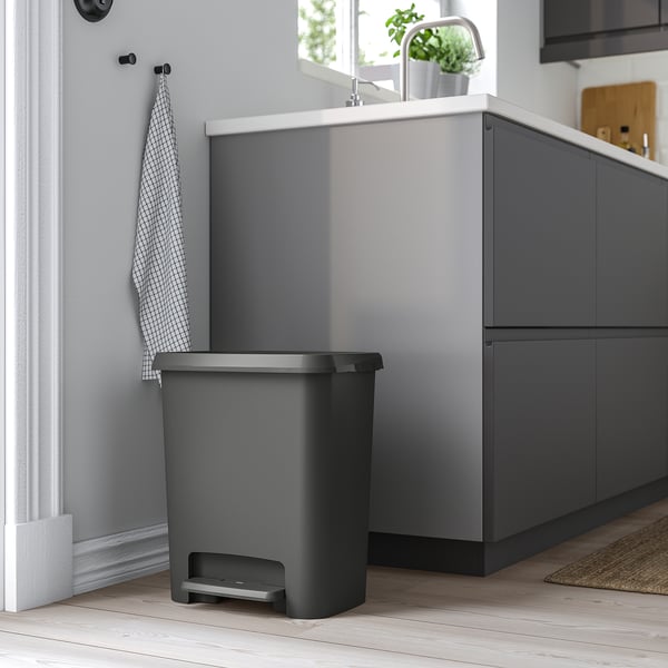 KNÖCKLA grey pedal bin in kitchen, fits under sink, with grey inner bins, round corners, plastic feet.