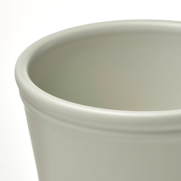 Close-up view of smooth, matte-finished planter, showing its sturdy, light green earthenware quality.