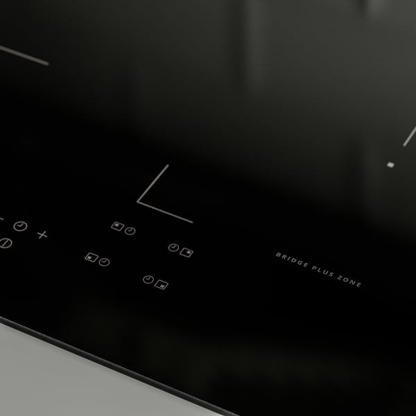 Modern induction cooktop with touch controls, sleek black surface, and bridge plus zone label.