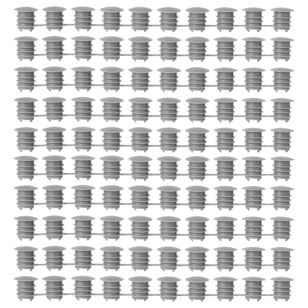 Grid of grey KOMPLEMENT polyethylene plastic cover caps, uniformly arranged, cylindrical shape with ridged design.