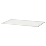 A white KOMPLEMENT glass shelf. Its rectangular, made of fibreboard and tempered glass, with a clean, modern design.