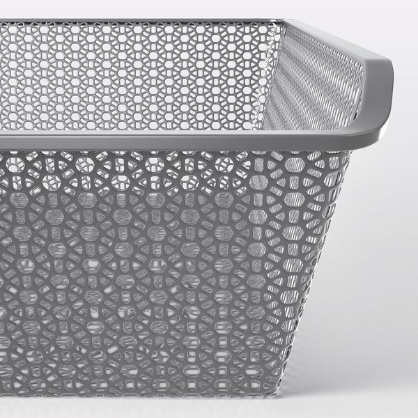 Grey metal mesh storage basket with intricate circular patterns, part of KOMPLEMENT series, excellent for air circulation and organisation.