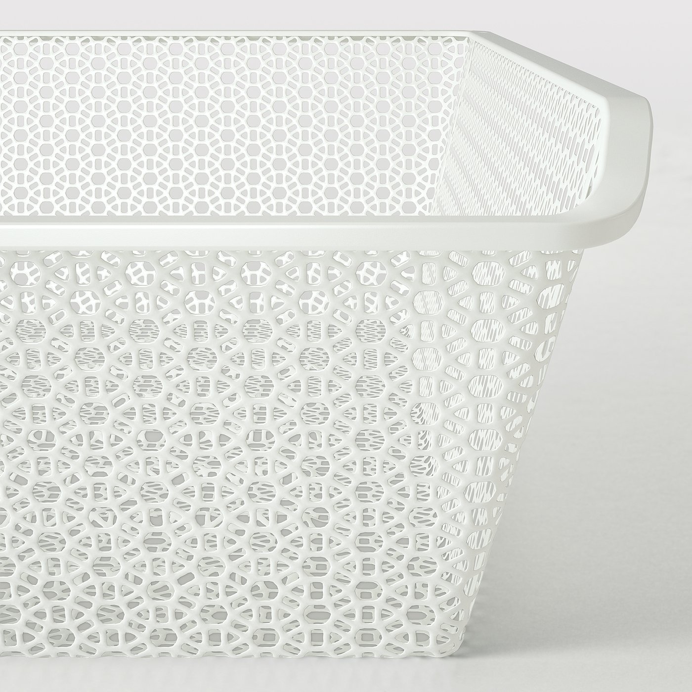 White perforated metal basket, part of KOMPLEMENT series, with intricate patterns, suitable for clothes and accessories, offering air circulation.