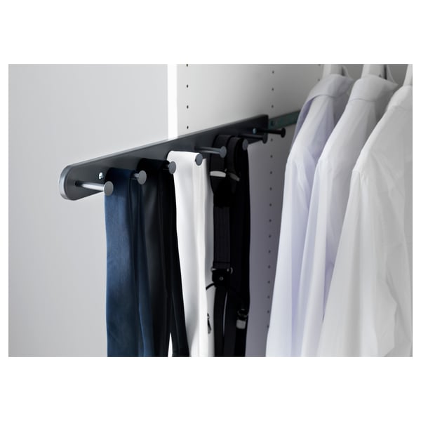 A white wardrobe with KOMPLEMENT organisers. Belts and ties hang on metal hooks.