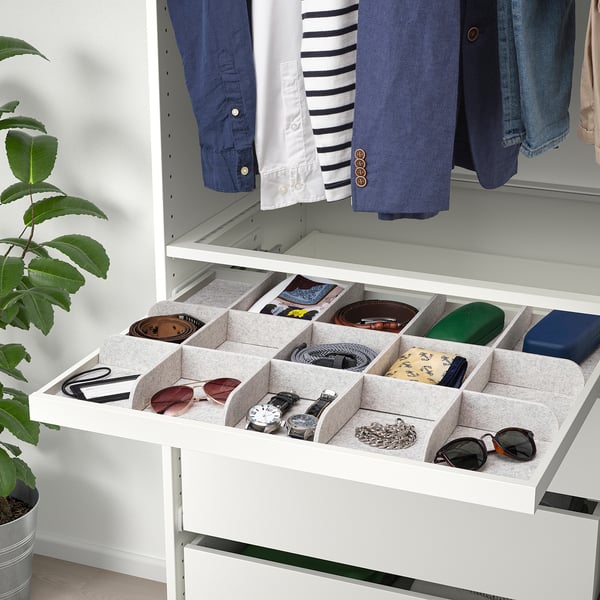 Open drawer organiser with compartments for accessories, belts, watches, and other small items.