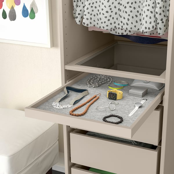 Open drawer shows jewellery organiser with necklaces, bracelets, and watches on felt mat.