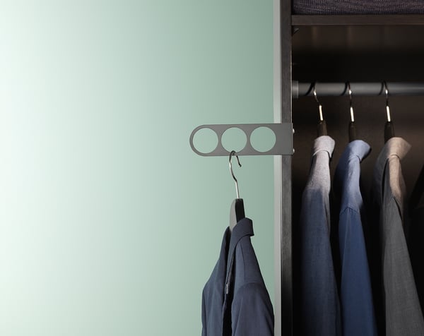 KOMPLEMENT grey valet hanger holds clothes neatly in wardrobe, mounted inside for clean look.