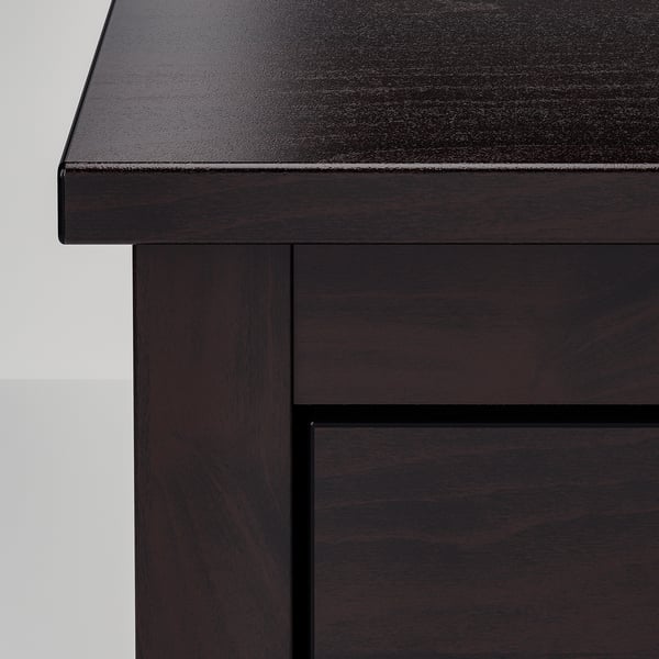 Dark wooden furniture close-up; smooth surface, sturdy build.