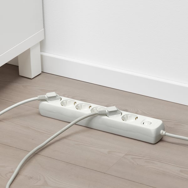 White surge protector with 6 sockets and switch on floor.
