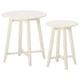 Two white, round nesting tables with sleek, tapering legs, designed by IKEA.