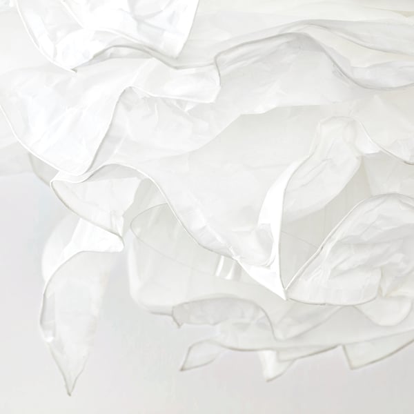 Soft, textured white paper lamp shade with gentle folds and wrinkles, emitting a warm, diffused light.