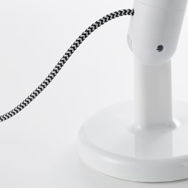 Modern floor lamp with sleek white base and adjustable patterned shade.