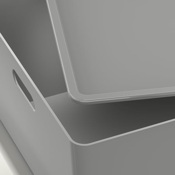 Close-up of a sleek, modern storage box; smooth grey finish, handle detail.
