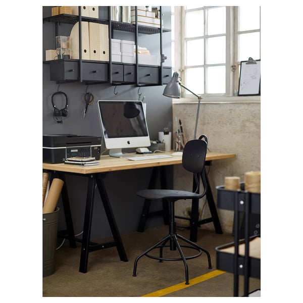Modern industrial office desk setup with KULLABERG black swivel chair, apple imac, and black metal shelves.