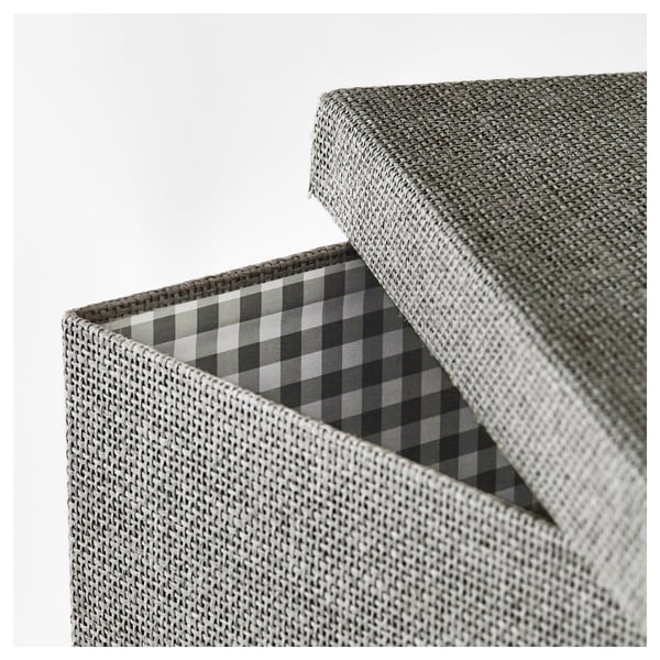 Closed storage box made of intricately woven paper. The lid is slightly ajar, revealing a chequered patterned interior.