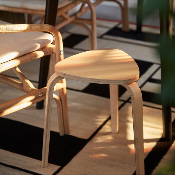 KYRRE wooden stool, light finish, triangular seat, three legs, stacked with chairs.