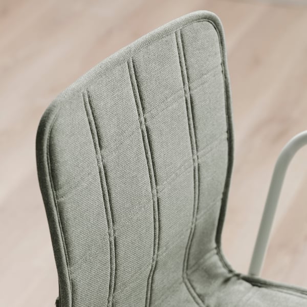 Close-up of a stylish, upholstered chair back, showcasing its sleek design and high-quality fabric.