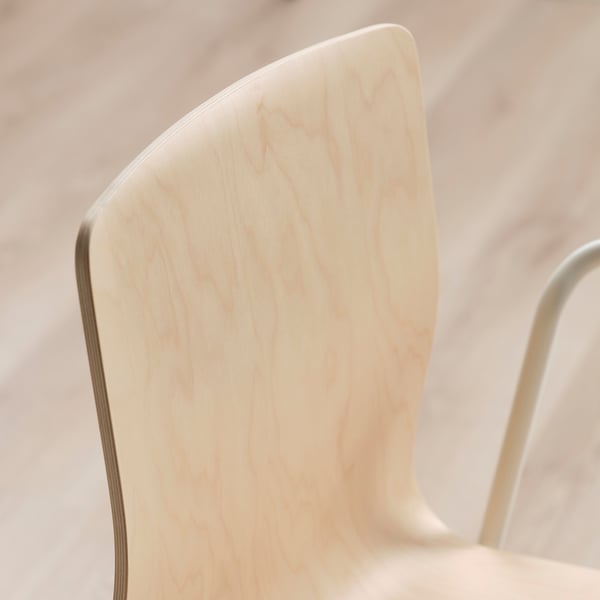 Close-up of light birch veneer chair back, smooth surface and clean design.