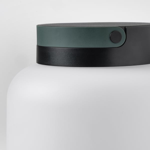 Modern led lamp with sleek black and green design, featuring a sturdy handle and compact shape. Perfect for indoor or outdoor use.