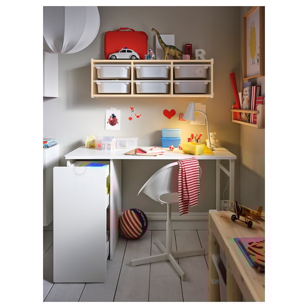 Childs study area with white LÄRANDE desk, adjustable chair, and storage units, decorated with toys and books.