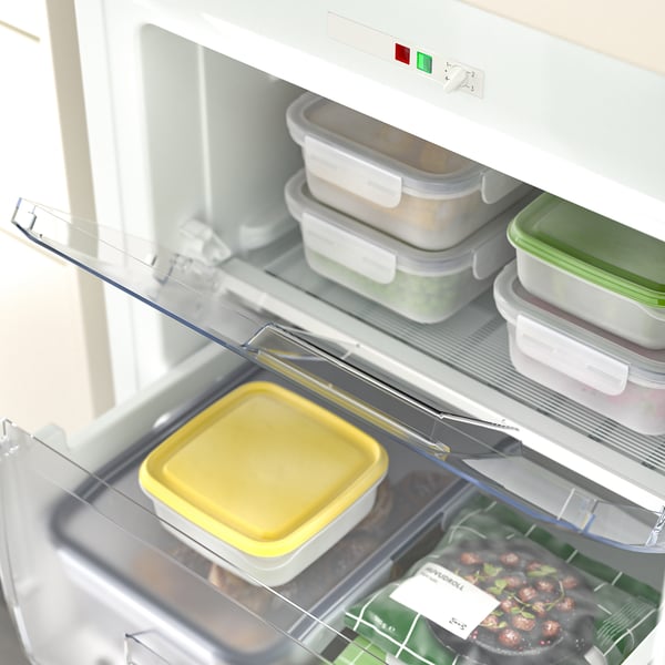 Small fridge with clear drawers showing contents. Integrated design, fits in kitchen cabinets.
