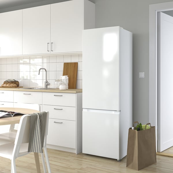Modern kitchen with large LAGAN fridge/freezer and wooden countertop.