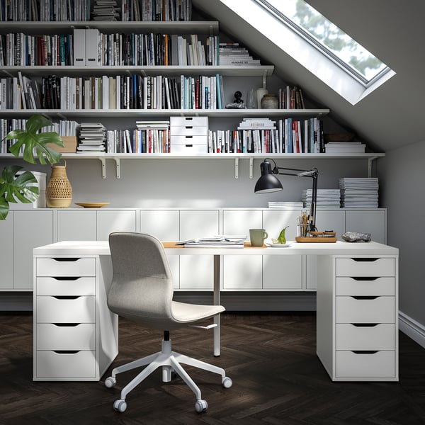 Home office with LAGKAPTEN desk, storage, books, ergonomic chair, skylight.