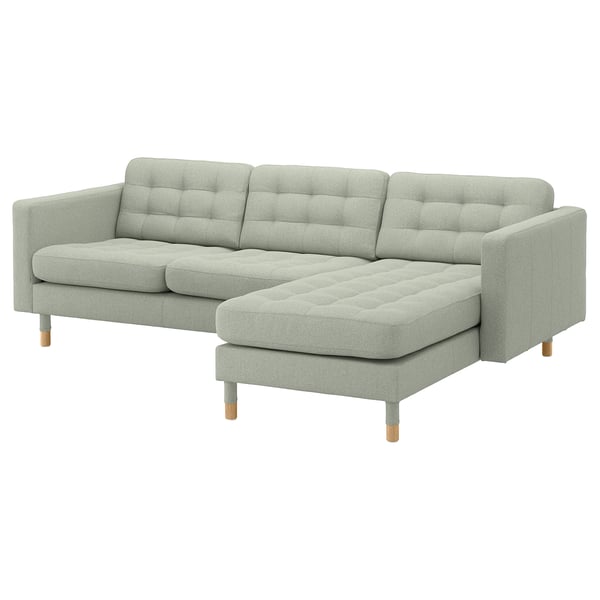 Light gray l-shaped sofa with soft cushions and wooden legs.