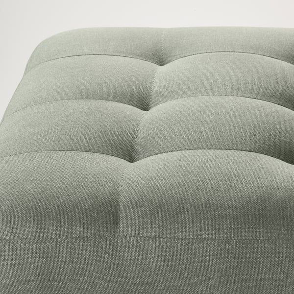 A close-up of a LANDSKRONA footstool, featuring its soft, tufted fabric and sturdy design.