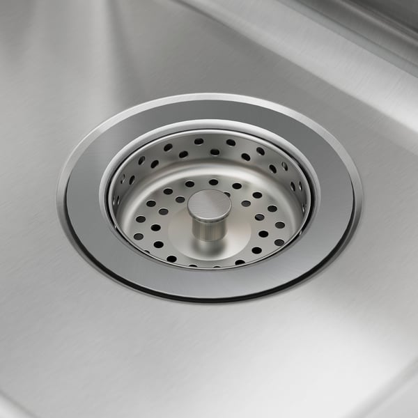 Stainless steel sink drain with strainer, sleek and polished surface.