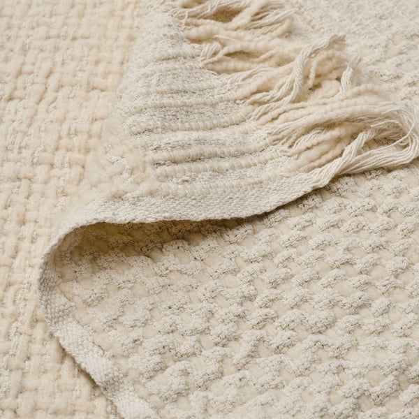Close-up of woven cream throw showcasing texture and quality. One side wool, one side cotton. Handwoven, soft, natural look.