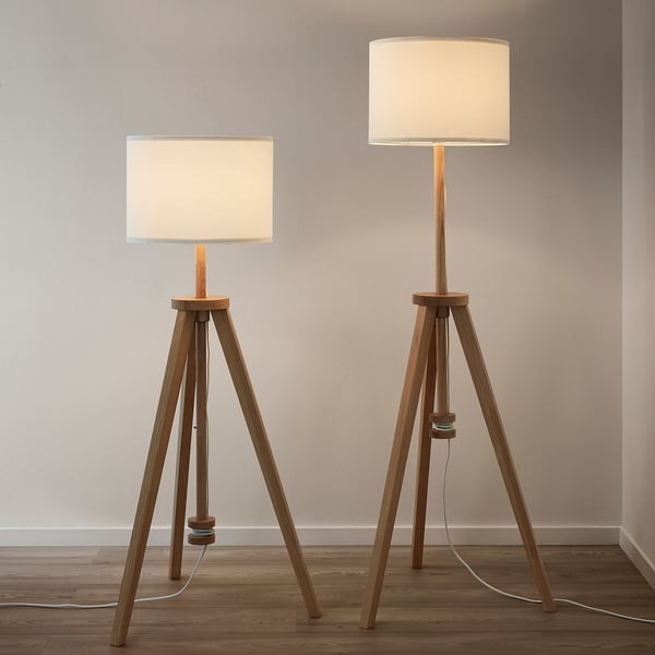 Two floor lamps with white shades on wooden tripod bases. The lamps have adjustable heights and hidden cords in the base.