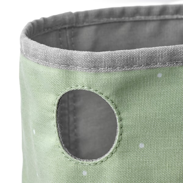 Green fabric container with grey edge and mesh pocket, showcasing quality stitching and texture.