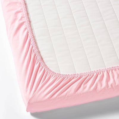 Pink fitted bed sheet with elastic corners, designed to stay secure on a mattress.