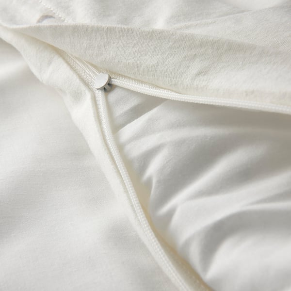 Close-up of soft, white baby duvet with zip detail.