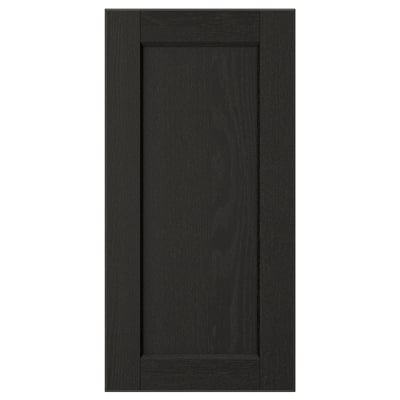 A black LERHYTTAN kitchen cabinet door with a solid wood frame, bevelled edges, and an inset ash veneer panel.