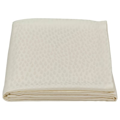 Folded cream-colored LIGUSTER tablecloth with textured pattern. Made from lyocell and viscose/rayon.
