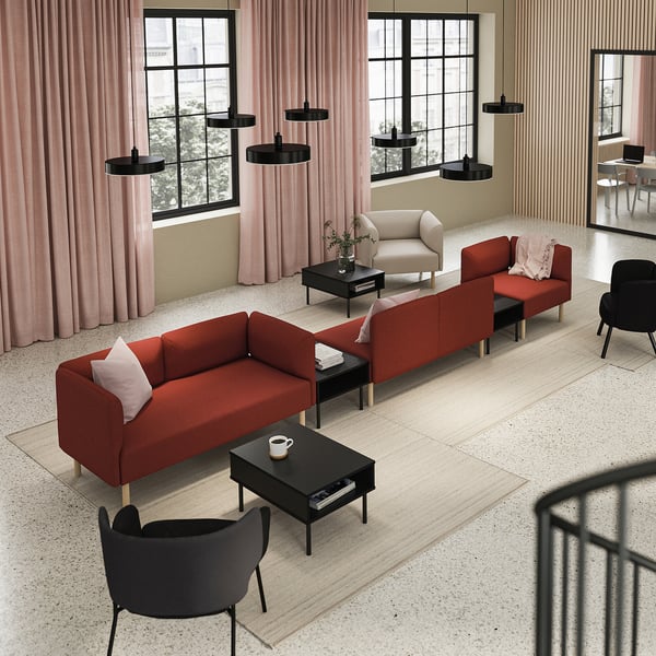Modern living room with three red LILLEHEM modular sofas, black side tables, pink curtains, and black chairs.