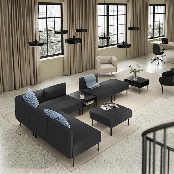 Modern living room with black LILLEHEM sofas, black tables, beigish chair, black office desk, curtains, and large windows.