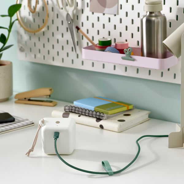 A workspace with a usb-c cable and desk organiser.