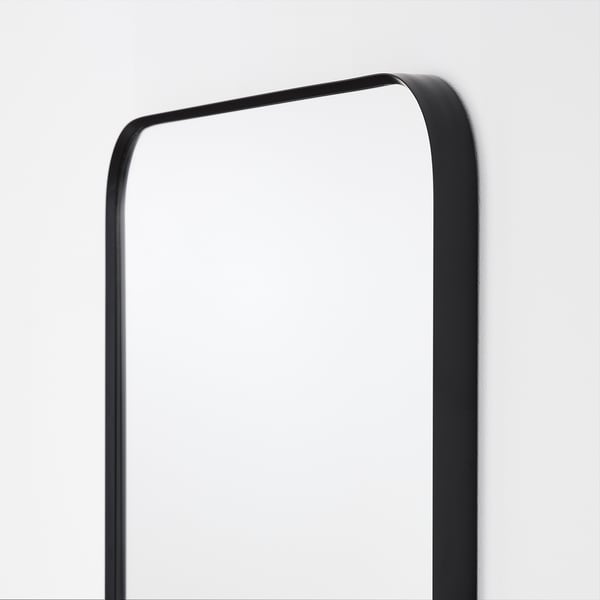 Modern black-framed mirror with rounded corners, reflecting elegance and simplicity.