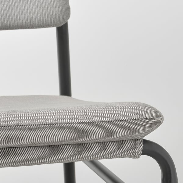 Close-up of a modern chairs seat and frame, showing high-quality fabric and sturdy metal.