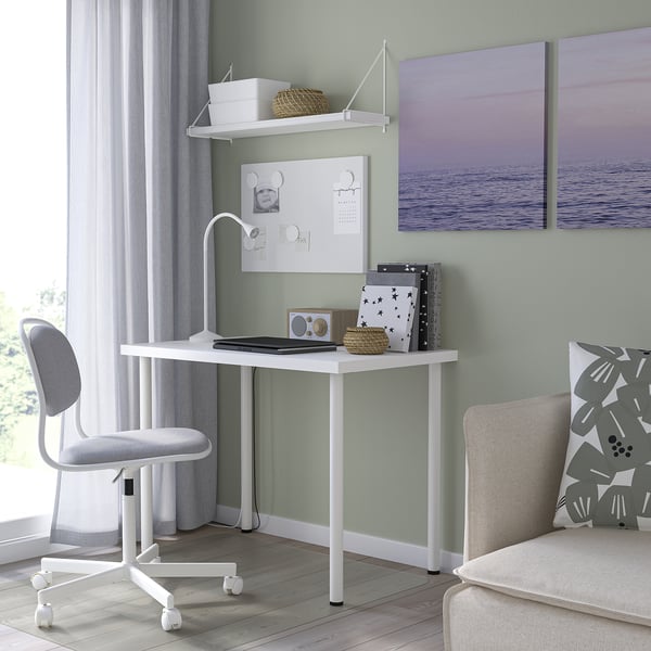 Small white l euro-style desk with chair and decor in room.
