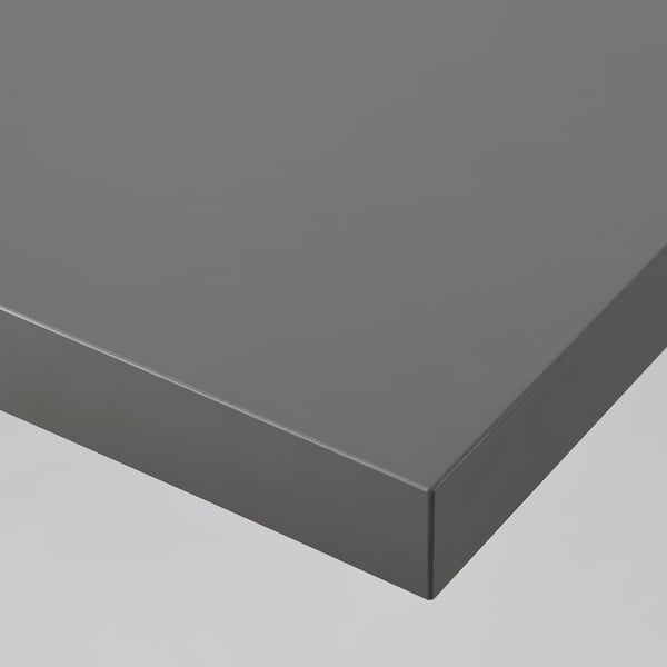 Modern, sleek grey desk with smooth, even surface. Contemporary design, solid edges.