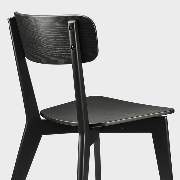 Black wooden chair with sleek, modern design. Sturdy and comfortable, featuring ash veneer and birch wood for durability and style.