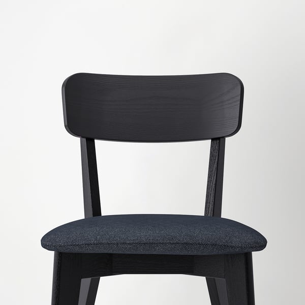 Dark wood chair with dense, dark fabric seat, simple, sturdy design.