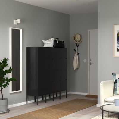 Black LIXHULT storage unit in hallway with mirror, rug, chair.