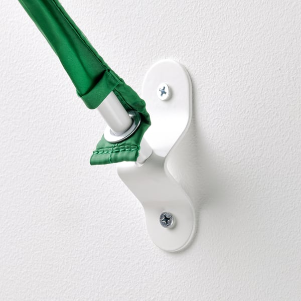 A green fabric tent is attached to a white wall bracket, securely fastened with screws, ensuring durability and safety.