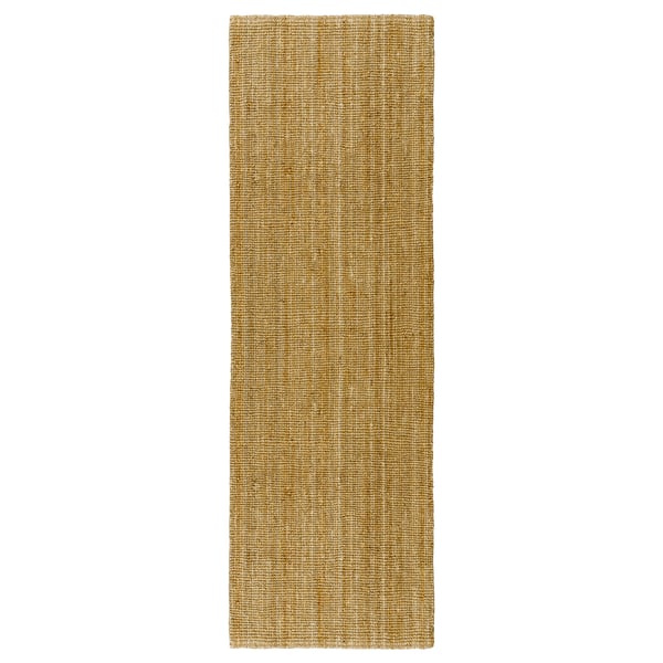 A natural tan jute LOHALS rug, rectangular with a simple, textured surface.