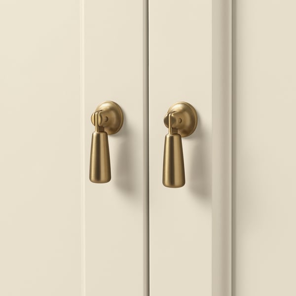Golden handles on clean white doors; sleek and modern design.